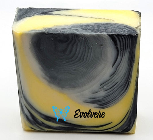 A white, black, yellow and gray swirled bar of soap.