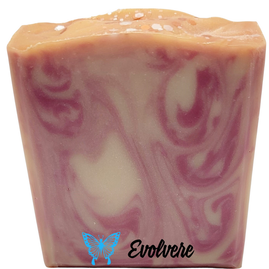 A pinkish tan bar of soap with a lighter swirl design .