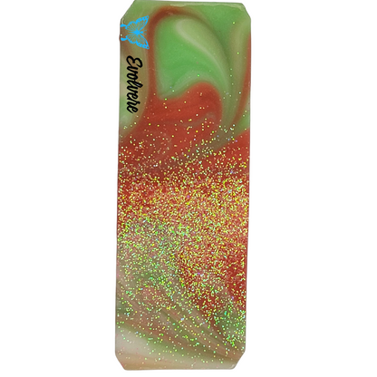Top of soap , green, red and white swirls topped with biodegradable glitter.