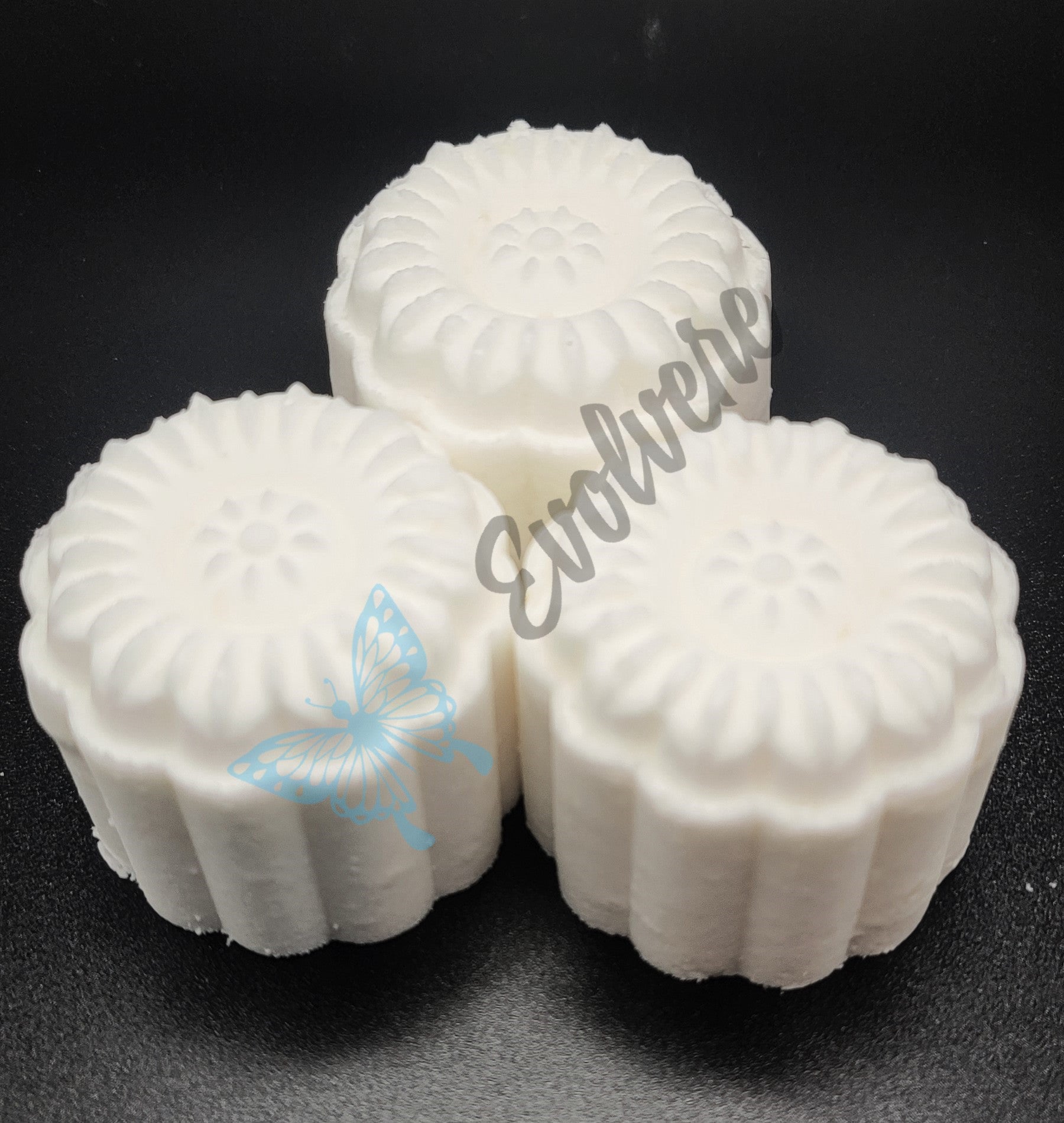 Three (3) white shower steamers in a flower shape. 