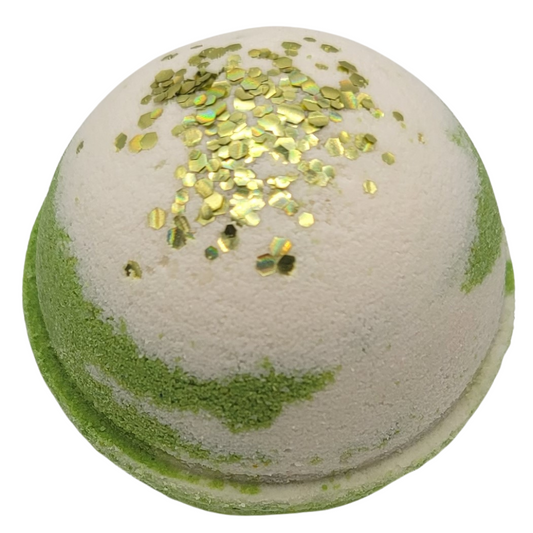 A white and green round bath bomb topped with a chunky gold plant based glitter. 