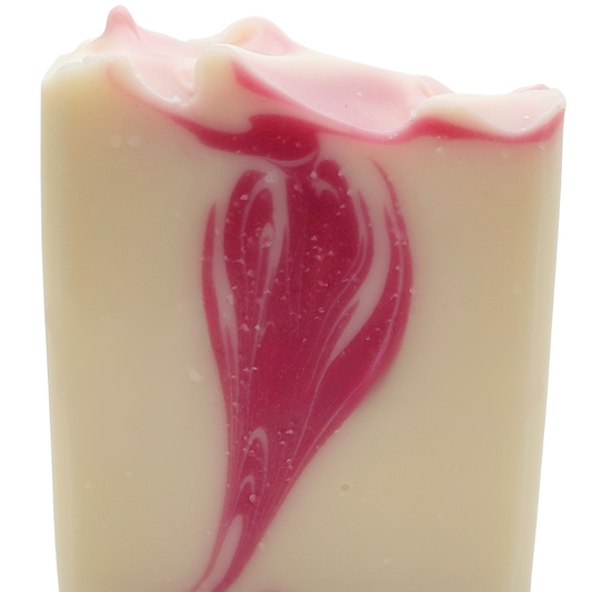 White bar of soap with a pink swirl which is designed to look like a flower bloom. 