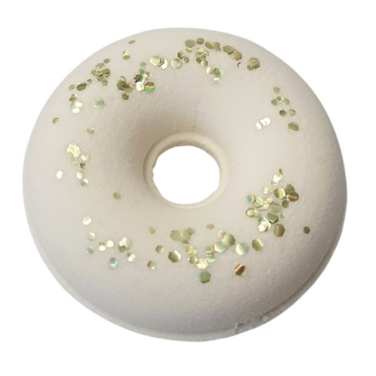 White donut shaped bath bomb topped with gold biodegradable glitter.