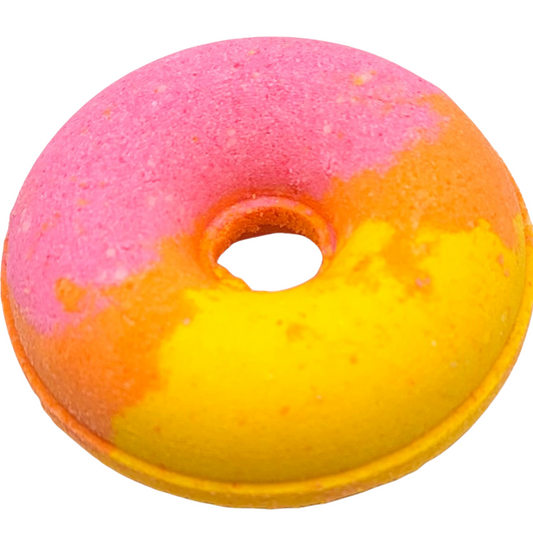 A beautifully colored pink, orange and yellow donut shaped art bath bomb. 