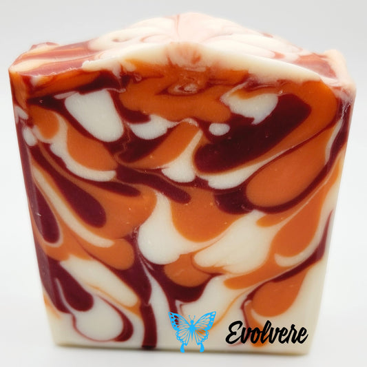 A beautiful drop swirl soap in white, deep burgundy and orange.