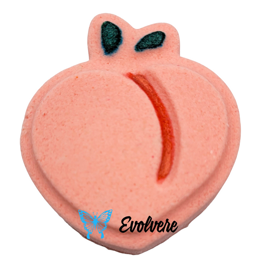 Peach shaped and Peach colored bath art bomb with green leaves.