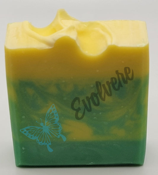 A yellow and green bar of soap with the top being yellow, the bottom green and the two colors are swirled in the middle. 