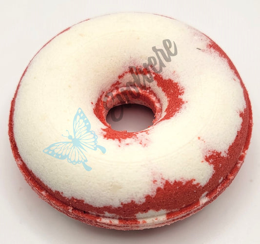 A red and white donut shaped bath bomb.