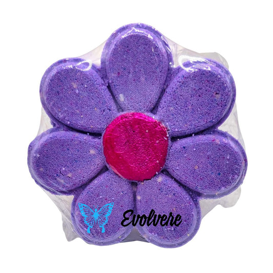 A purple flower bath bomb that releases multiple colors to create bath art.