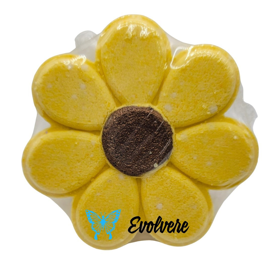 A yellow flower bath bomb that releases multiple colors to create bath art.