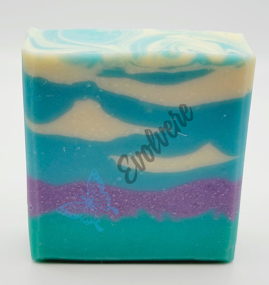 Bar of soap with design to mimic field of violets and clouds in sky.  