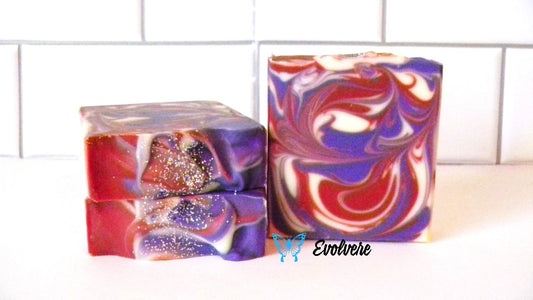 A burgendy, purple and white swirled soap topped with silver biodegradable glitter.