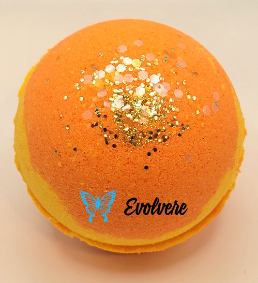 Round yellow and orange bath bomb with gold and iridescent biodegradable glitter