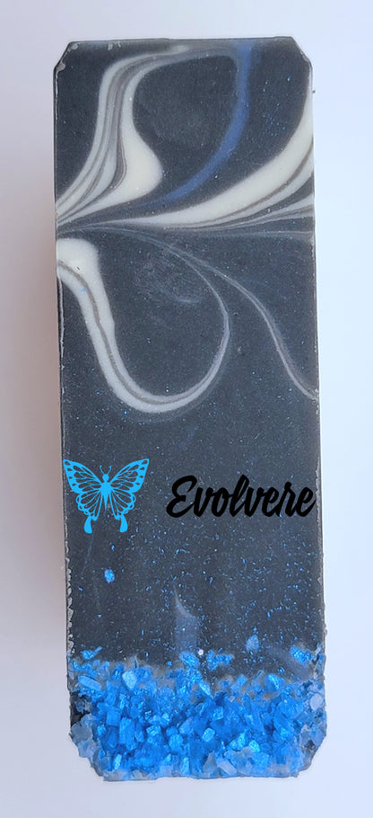 A black soap top with white swirls and blue sea salt..