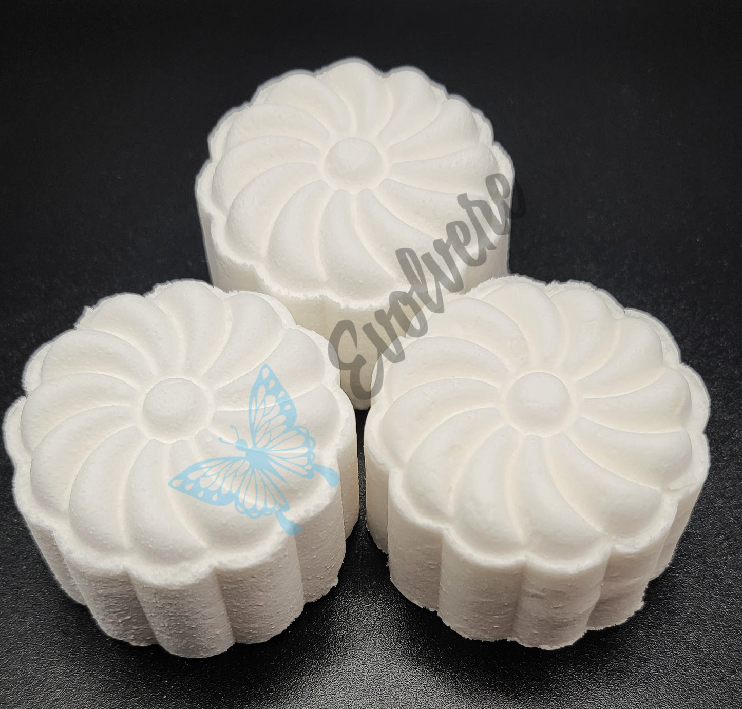 Three (3) white shower steamers in a flower shape. 