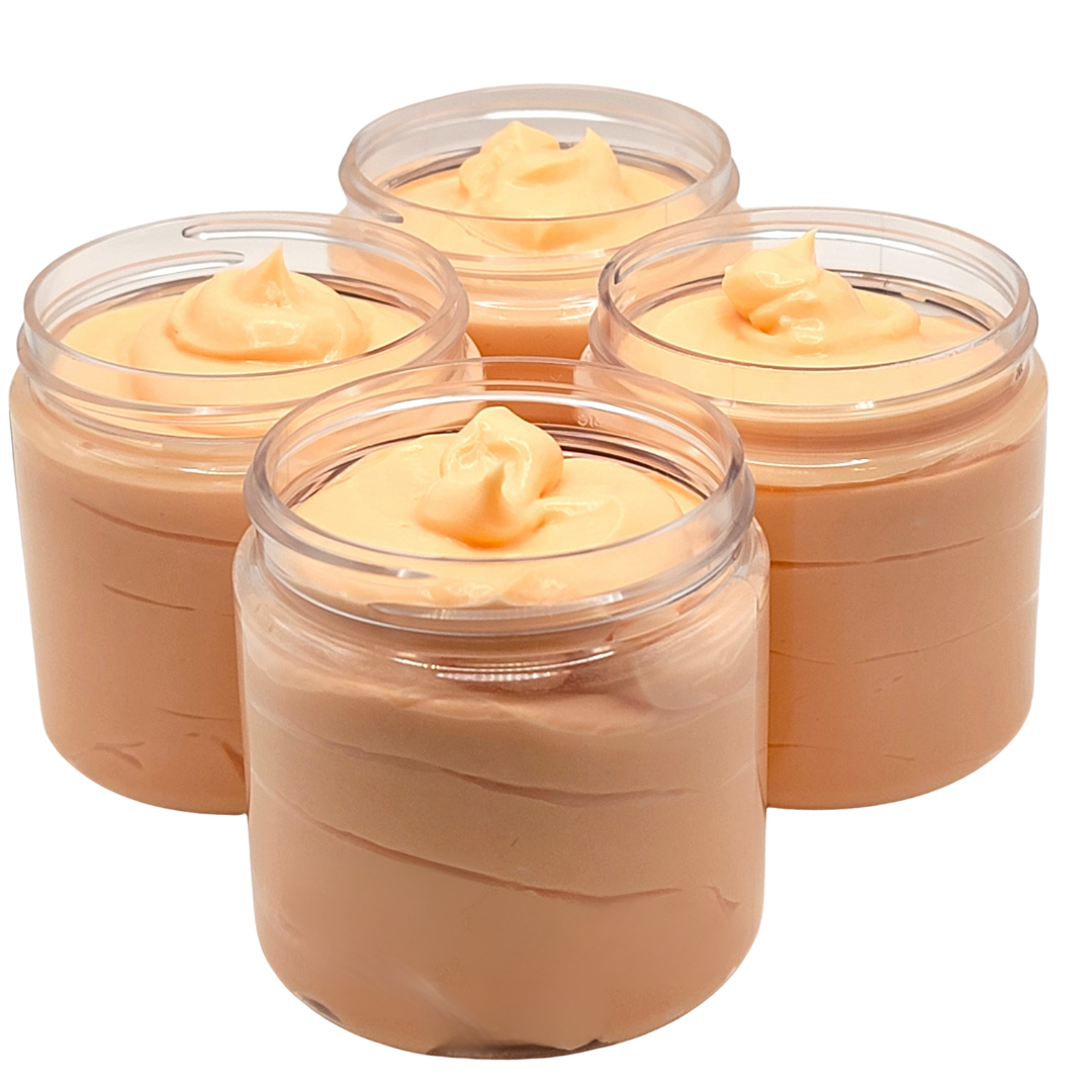 Light orange body butter in clear 4oz jar