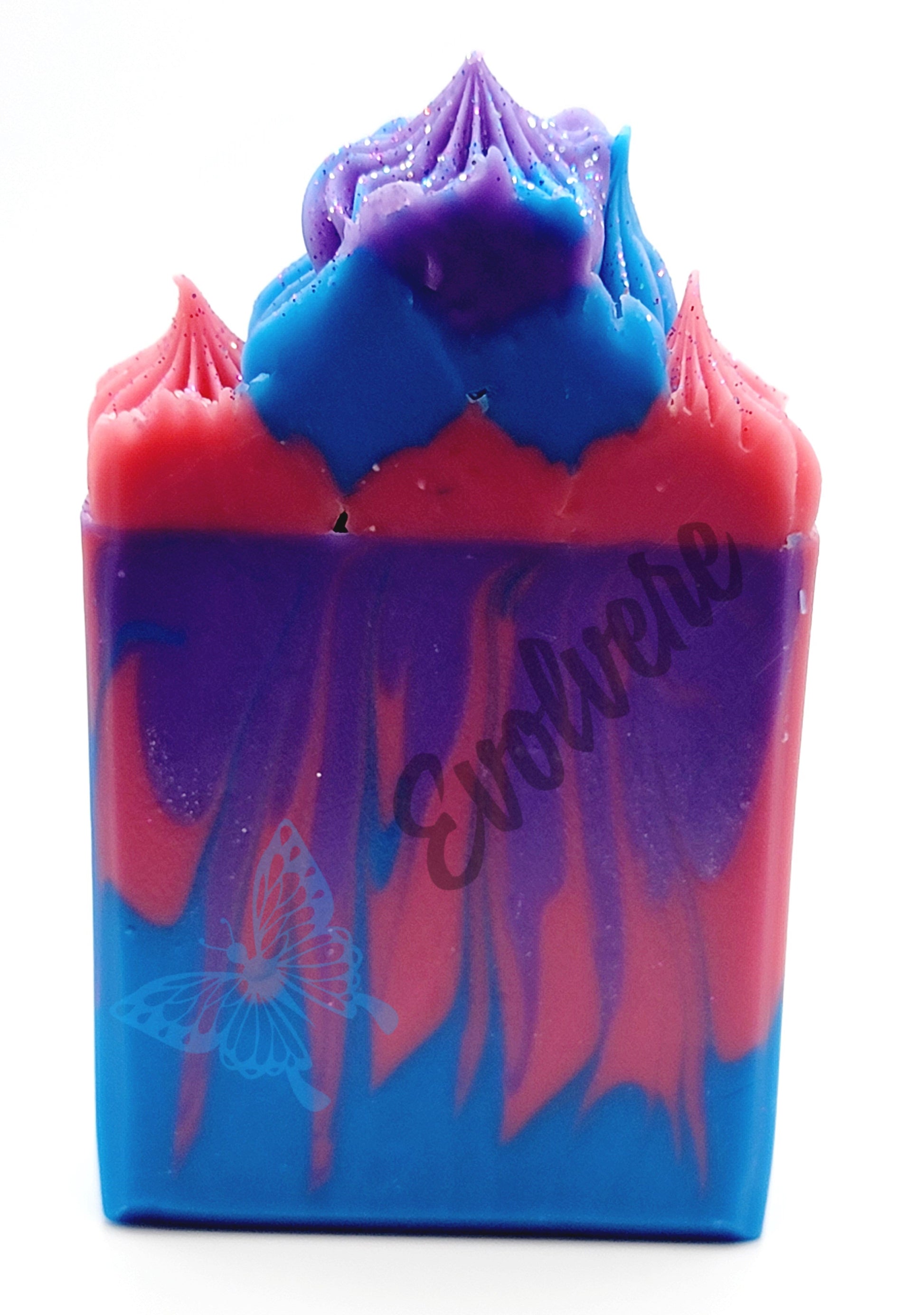 A high-topped soap in blue, pink and purple with a splash swirl. Topped (frosted) top to build height and topped with biodegradable glitter. 