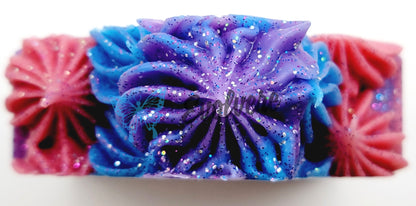 Blue, pink and purple soap top that has been piped to add texture and height. Topped with biodegradable glitter. 